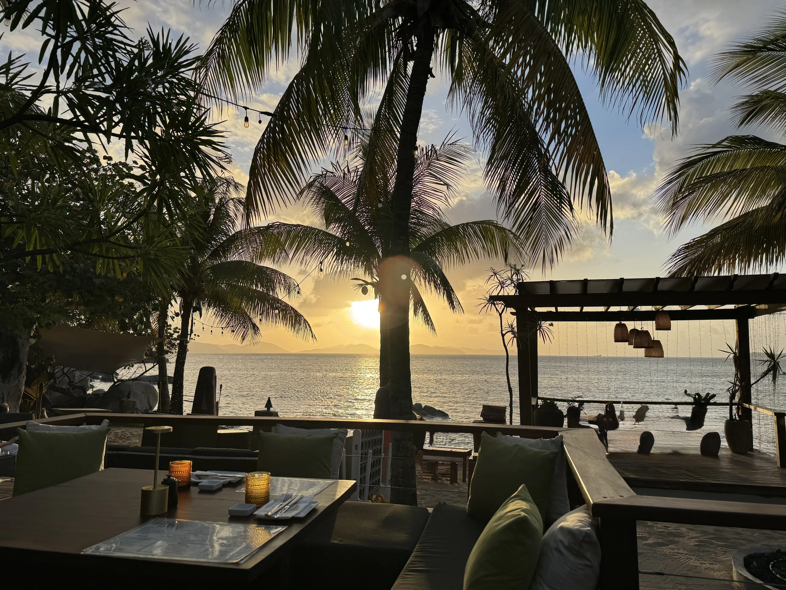 Sunset over the water from a beachfront dinner table at CocoMaya, Virgin Gorda, BVI